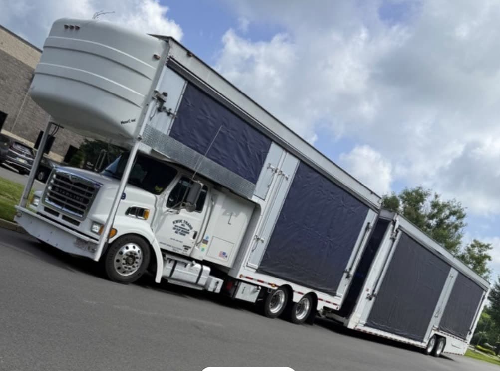 Enclosed auto transport trailer for high-value vehicle shipping