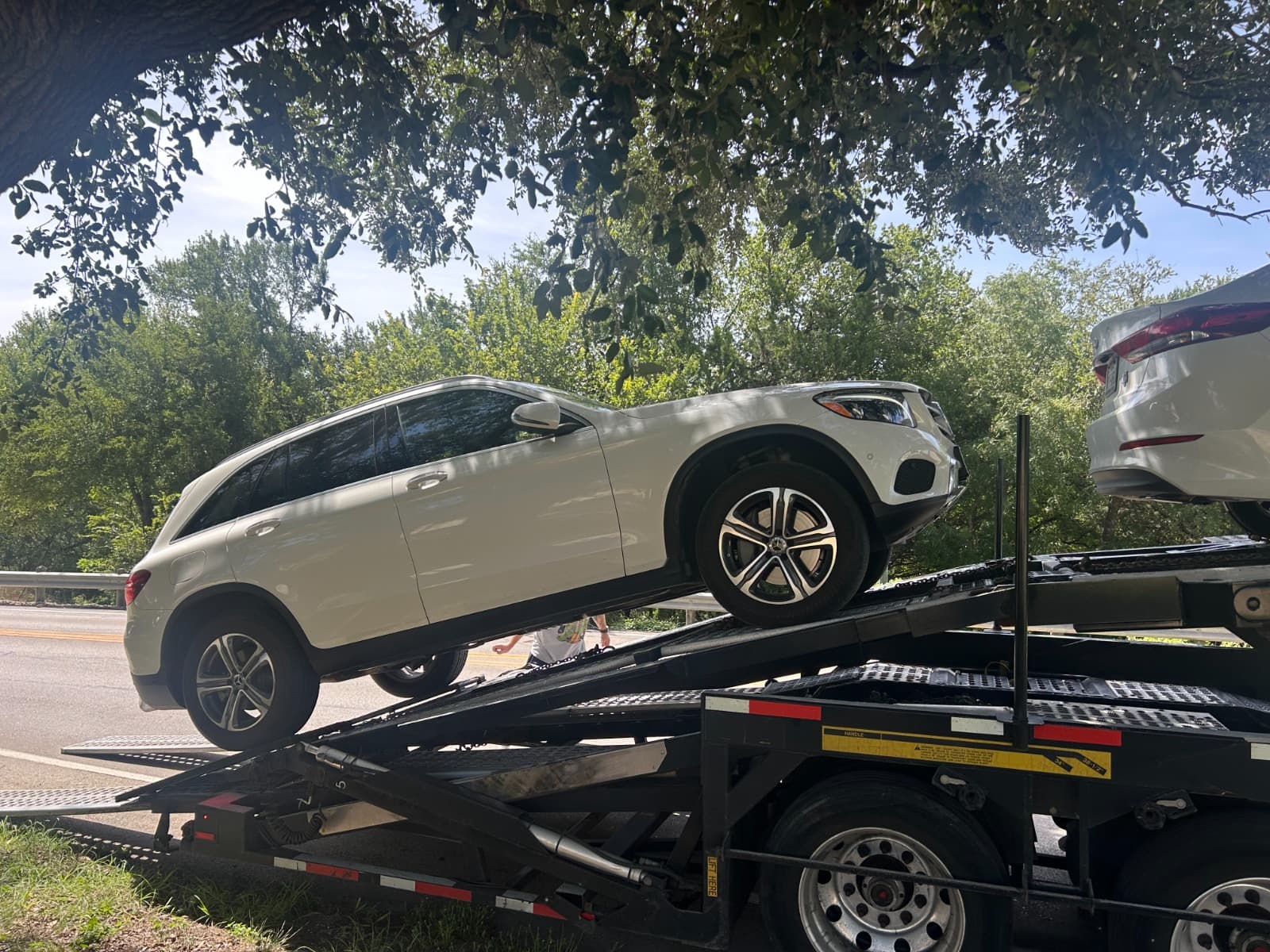 Mercedes-Benz GLC 300 being loaded onto an open auto transport carrier