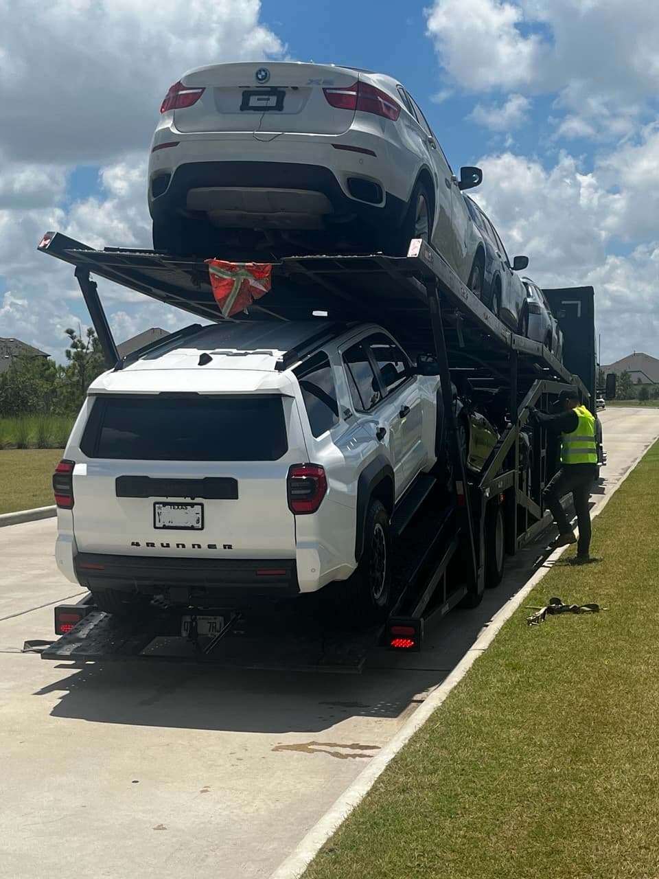 2025 Toyota 4Runner loaded on an open auto transport carrier in Cypress, TX