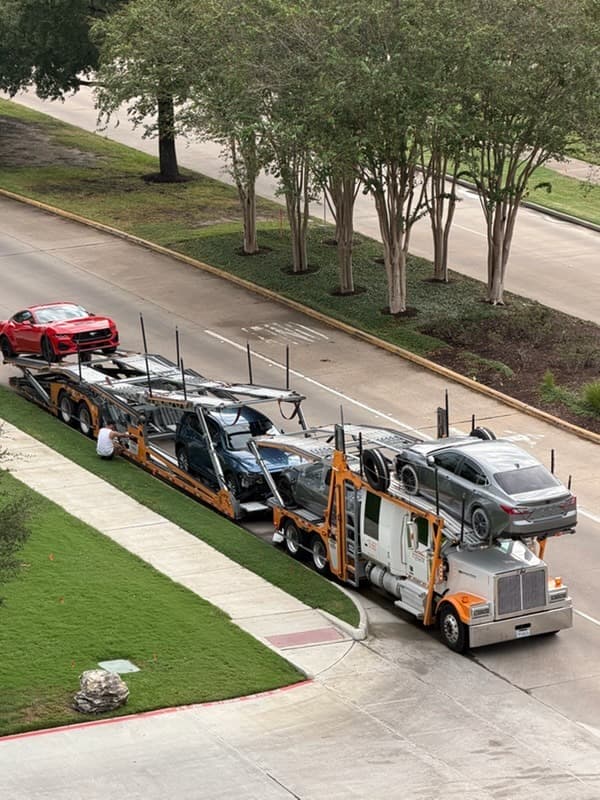 2024 Ford Mustang on an open auto transport carrier for shipment from Houston to Modesto