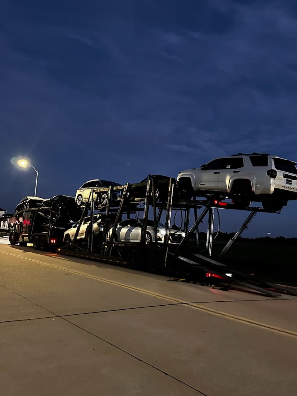 Open auto transport carrier carrying the 2016 Nissan Altima from Crosby, TX to Miami, FL