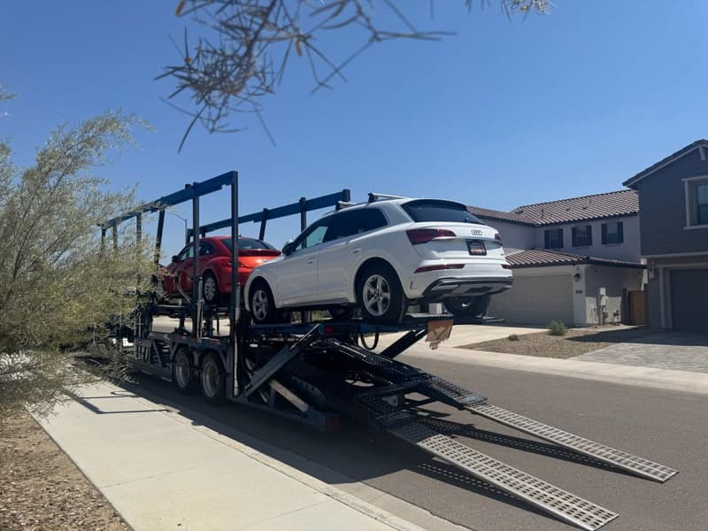 2024 Audi Q5 secured on an open auto transport carrier ahead of departure from Glendale, AZ