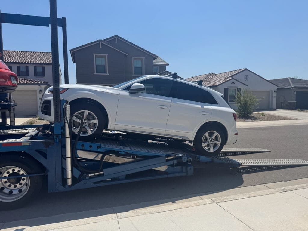 2024 Audi Q5 being loaded onto an open auto transport carrier in Glendale, AZ