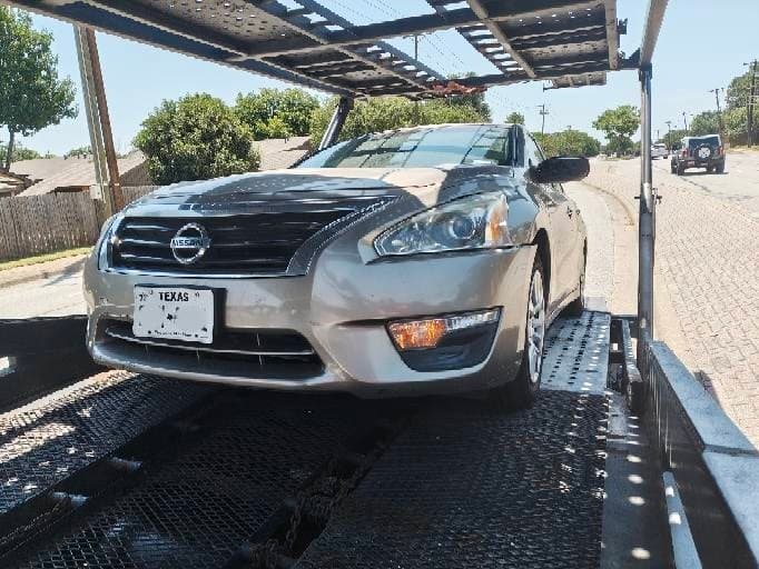 2016 Nissan Altima loaded on an open auto transport carrier in Grapevine, TX