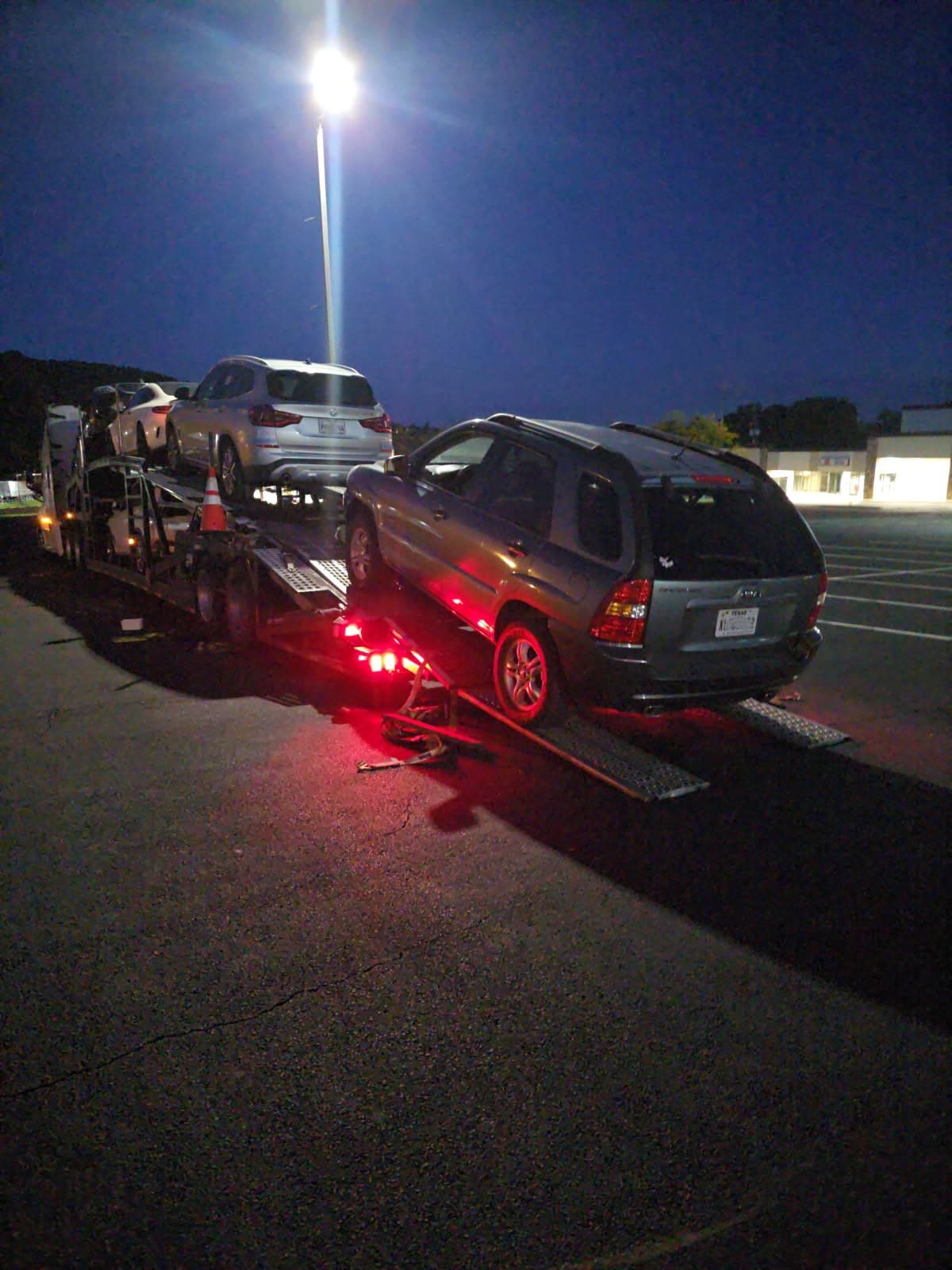 2007 Kia Sportage on an open auto transport carrier for shipping from Richmond, TX to Reading, PA