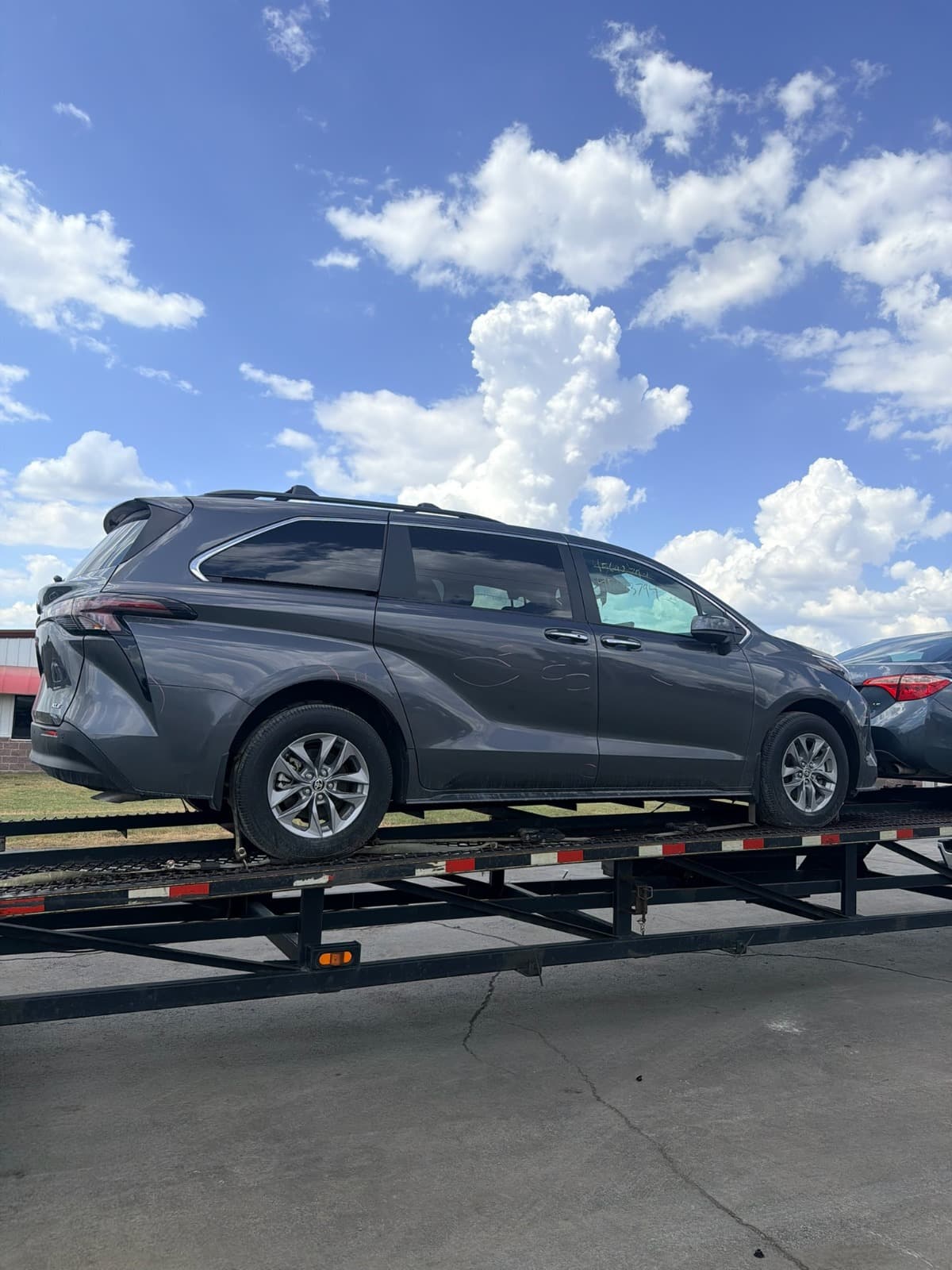 2025 Toyota Sienna loaded on an open auto transport carrier