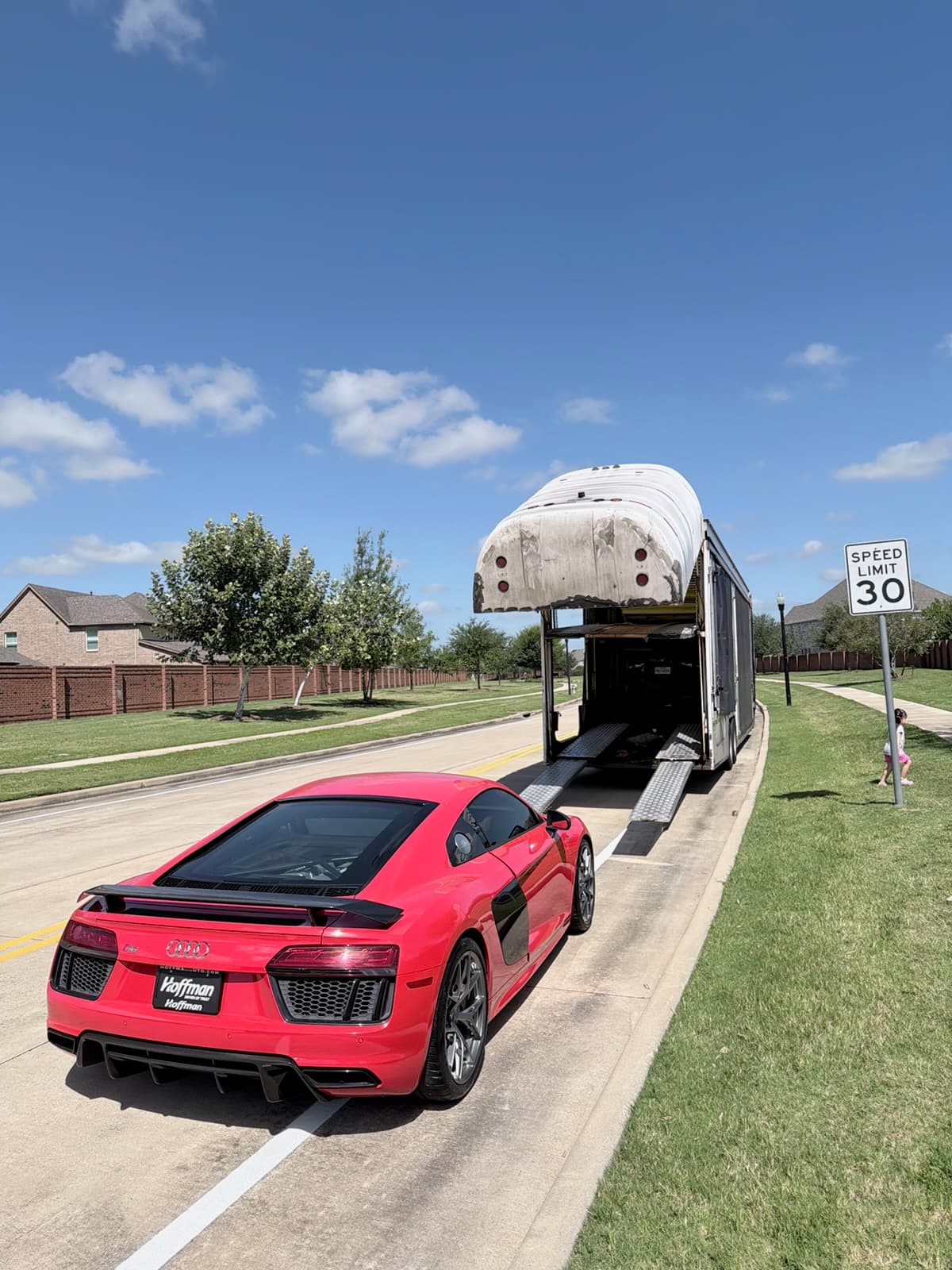 Audi R8 approaching an enclosed auto transport trailer for loading